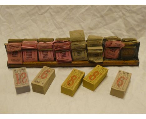 A bus conductor's 13" wooden double-sided ticket holder with a selection of original bus tickets