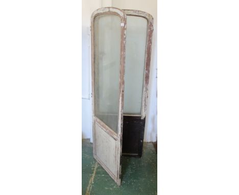 A distressed French painted four fold screen, a single square panel under arched top glazing to each leaf, each 175 x 61 x 2c