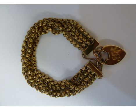 An antique gold bracelet, c1900, composed of four rows of fancy chain links to a heart shaped padlock clasp, total weight 34g