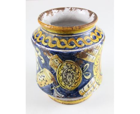 A 19thC Maiolica Albarello, in Sicilian style, painted with a turk within 'C' scroll reserve on a band of trophies of war, pa
