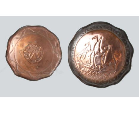 Two Arts & Crafts copper chargers, one with Cornwall, hunting horn and crown; the other with a galleon in full sail, 39cm max