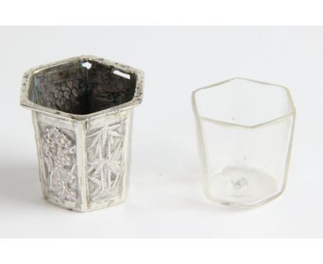 A Chinese silver inkwell, with glass liner of hexagonal section, each panel with characters, bamboo, prunus, grapes and other
