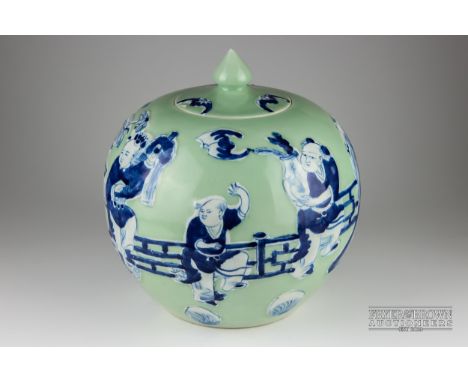 A Chinese porcelain celadon ground blue and white jar and cover, globular decorated with figures, tables and vase of lotus fi