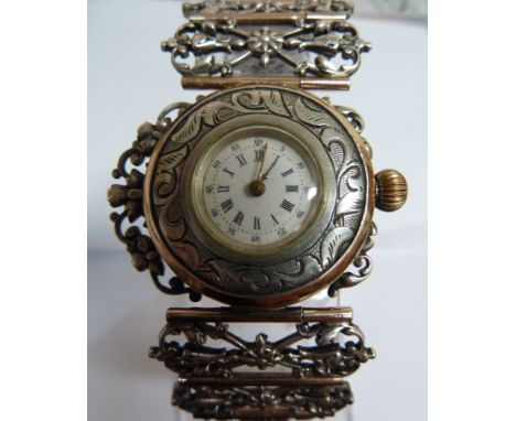 An unusual French silver and gold ladies wrist watch, c1880, the circular white enamel dial with black painted Roman numerals