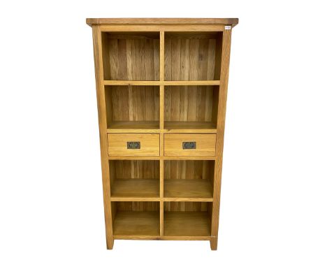 Light oak eight compartment bookcase with two drawersDimensions: Height:&nbsp;180cm&nbsp; Length/Width:&nbsp;100cm&nbsp; Dept
