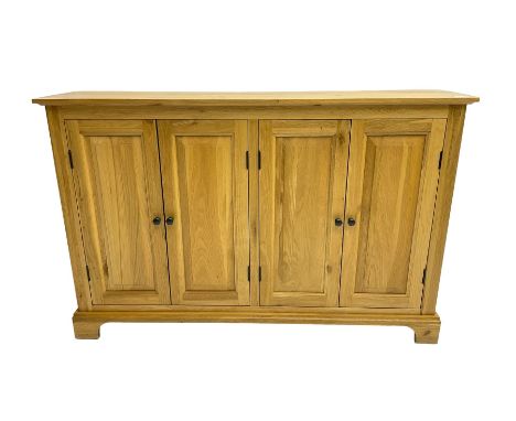 Light oak sideboard, fitted with four panelled cupboards Dimensions: Height:&nbsp;82cm&nbsp; Length/Width:&nbsp;127cm&nbsp; D