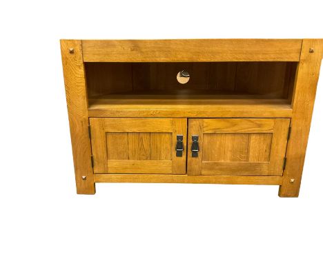 Solid light oak corner television stand, chamfered rectangular top over single shelf and two panelled cupboard doorsDimension