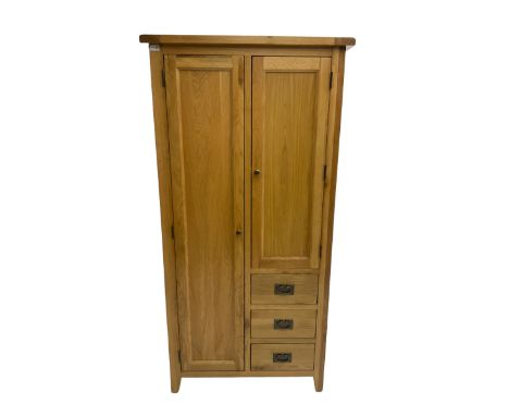 Solid light oak combination wardrobe, fitted with one cupboard enclosing hanging rail, the shorter cupboard above three drawe