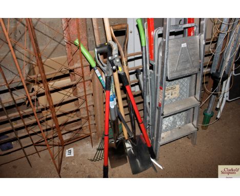 A collection of garden tools to include a fork; spade; rake etc