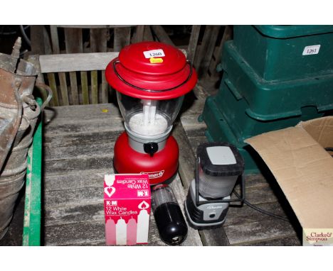 A Coalman electric lantern; a Cydalit lantern; a Kampa light and a box of candles