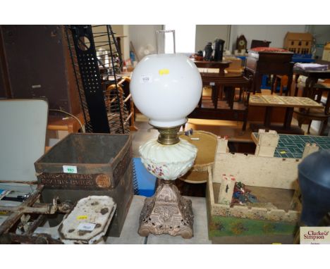 A glass oil lamp with milk glass shade
