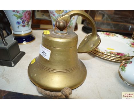 A brass bell and bracket 