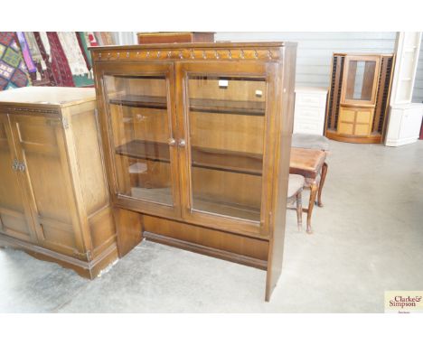 An upper section of an Ercol style bookcase