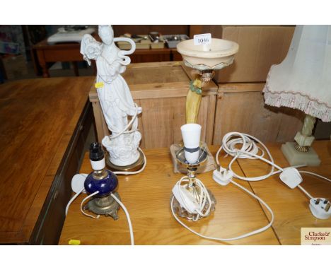 A Blanc de Chine figural decorated table lamp; a figural decorated plant stand and two other table lamps