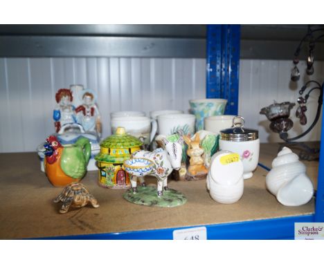 A quantity of various mugs, Staffordshire style candlestick, Wade whimsies, Royal Worcester egg coddler
