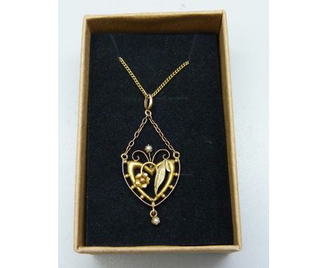 A 9ct gold and seed pearl pendant on a 9ct gold chain, 2.6g 