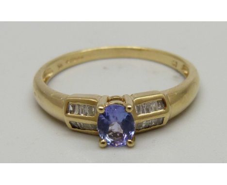 A 9ct gold, purple stone and baguette diamond set ring, 1.8g, P 