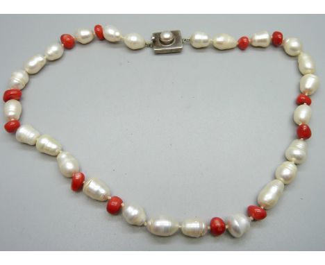 A pearl and coral necklace on a silver clasp 