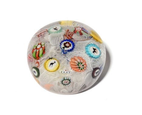 A small Baccarat latticinio paperweight, dated 1847, set with colourful floral and silhouette canes against a jumble of latti