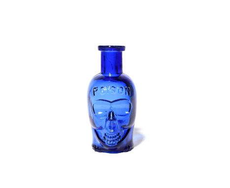 A Death's Head poison bottle of medium size, late 19th/early 20th century, the glass a rich cobalt blue, modelled as a skull 