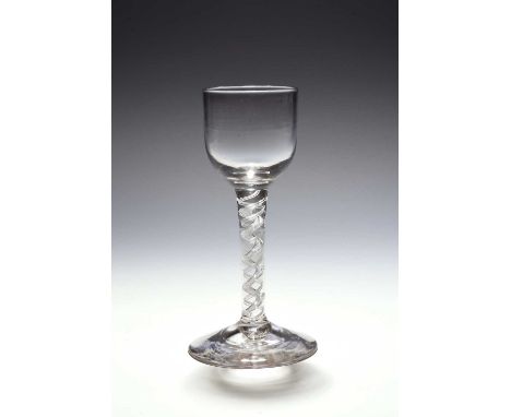 A small mixed twist wine glass, c.1760, the cup bowl raised on a mixed twist stem comprising thin opaque white strands spiral