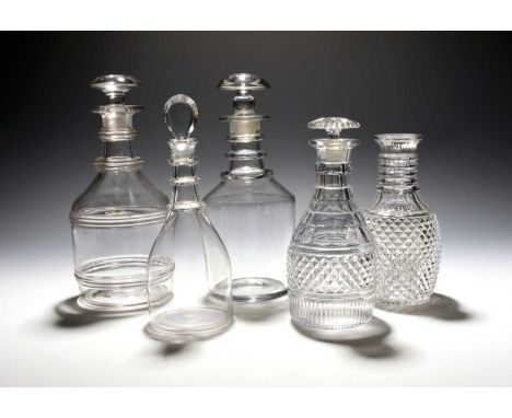 Four glass decanters and stoppers, late 18th/19th century, the smallest of Prussian shape with three neck rings, another appl