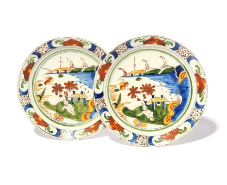 A pair of delftware plates, c.1720, brightly painted in blue, red, green and yellow with a Chinese figure recumbent before a 