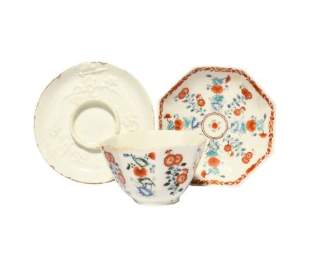 A Chelsea octagonal teabowl and associated saucer, c.1752-55, painted in Kakiemon enamels with panels of flowering plants, th
