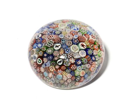 A large Baccarat millefiori paperweight, dated 1847, set with a multitude of colourful canes including animal silhouettes and