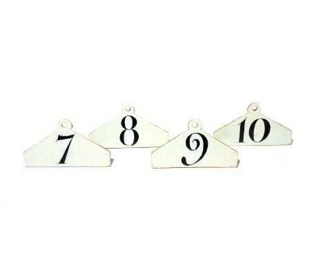 A rare part set of four London delftware wine or bin labels, c.1780, of coathanger form, each decorated in manganese with con
