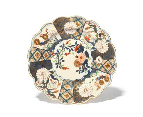 A Chelsea dessert plate, c.1752-58, richly decorated in the Imari palette with the Brocade pattern, with a spray of flowering