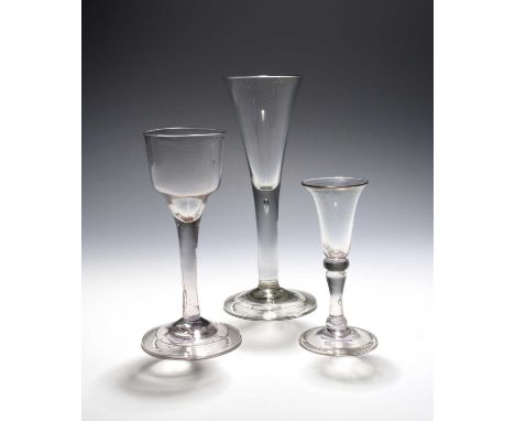 Three English drinking glasses, c.1730-50, including a small gin glass with bell bowl over a balustroid stem, a wine glass wi