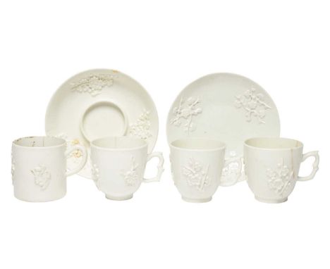 Three Bow white-glazed coffee cups and a small mug, c.1752-54, a trembleuse saucer and another saucer, all applied with sprig