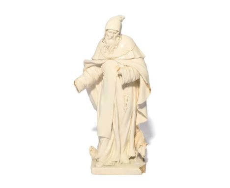 An Italian glazed pottery figure of St Anthony the Abbot, late 18th century, the bearded figure well modelled and wearing a l