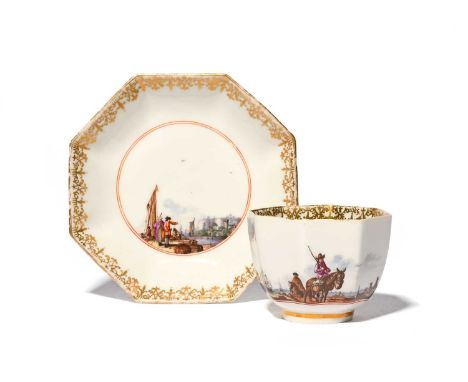A Meissen octagonal cup and saucer, c.1735-40, painted with kauffahrtei scenes of traders in harbour settings, within elabora