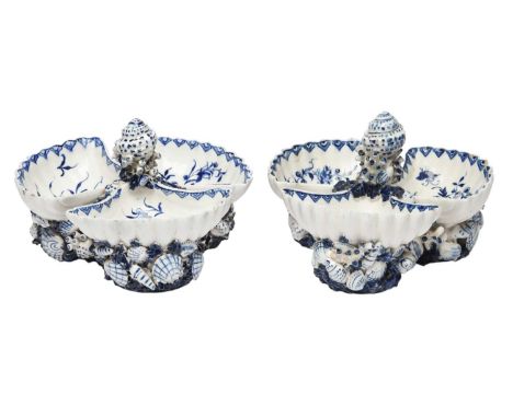 A pair of Bow blue and white sweetmeat stands, c.1760, each formed of three scallop shells around a central whelk shell, the 