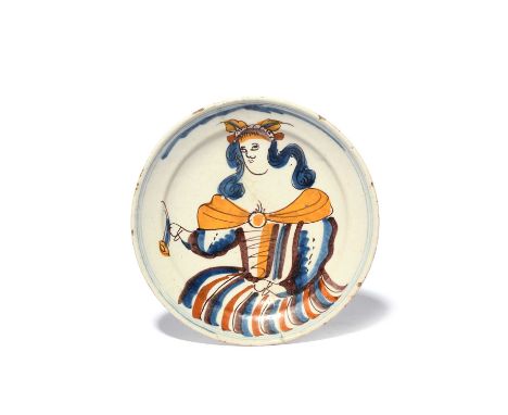 A delftware plate or shallow dish, c.1700, painted with the portrait of a women, possibly depicting Ceres, wearing a leafy di