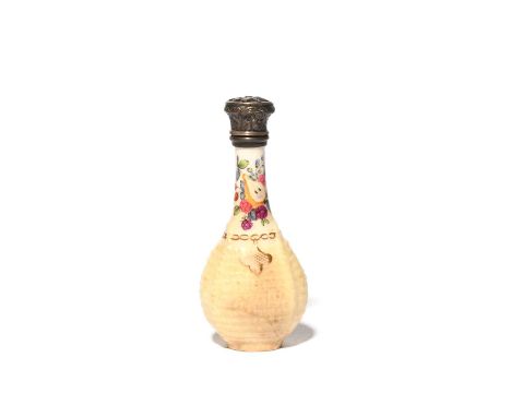 A Chelsea scent bottle, c.1760, the flattened flask form modelled as a bottle within a pale yellow basket with a gilt chain a