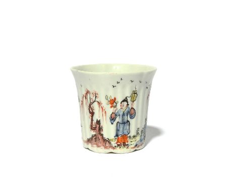 A rare early Worcester coffee cup, c.1753-54, the reeded form finely painted with a Chinese figure holding a flower spray and