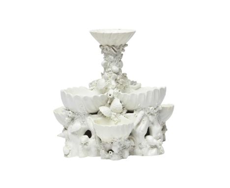A large Bow three-tiered sweetmeat stand, c.1760, left in the white and formed of six deep scallop shells beneath a circular 