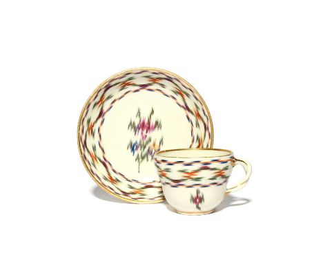 A Vienna cup and saucer, c.1780, the ogee form decorated in an ikat textile or chintz pattern on a white ground, blue shield 
