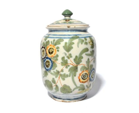 A Pesaro maiolica jar or albarello and cover, c.1780, painted with continuous flowering branches in green, blue, yellow and o