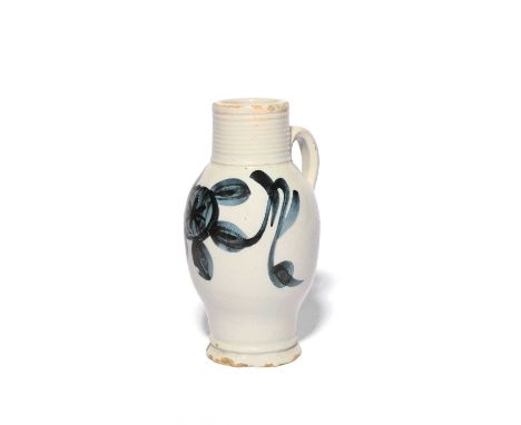 A London delftware tavern measure, c.1780-90, naively decorated with a sponged blue floral design beneath a ribbed neck, 16.5