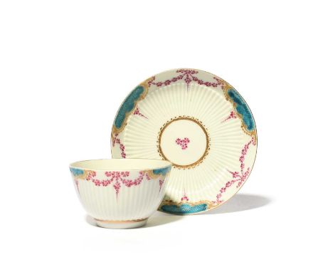 A Worcester teabowl and saucer, c.1770-75, with a fine band of reeding, painted with shaped panels of turquoise shagreen link