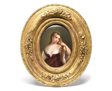 A Continental porcelain oval plaque, 19th century, painted with the portrait of a young woman in a low-cut dress, holding a l