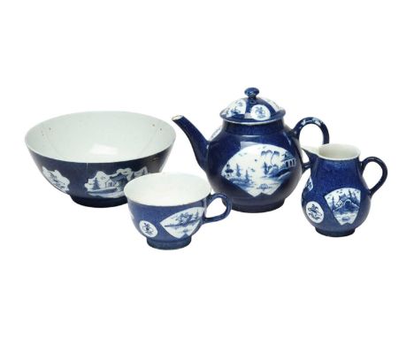 A Bow blue and white part tea service, c.1760-65, comprising a teapot and cover, a milk jug, a slop bowl and a teacup, decora