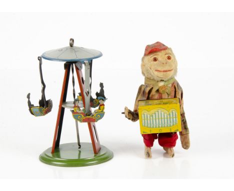 A Wilhelm Krauss Tinplate Fun Fair Boat Carousel Toy, with push down spiral mechanism, three detailed tinprinted boats with t