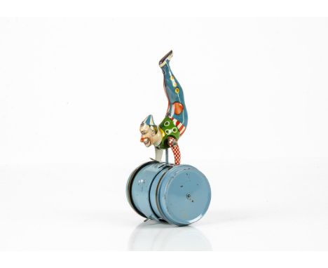 An Erco (Leonhard Erdel) Tinplate Clockwork Clown On Barrel, 1950s tin toy, light blue barrel with detachable detailed tinpri