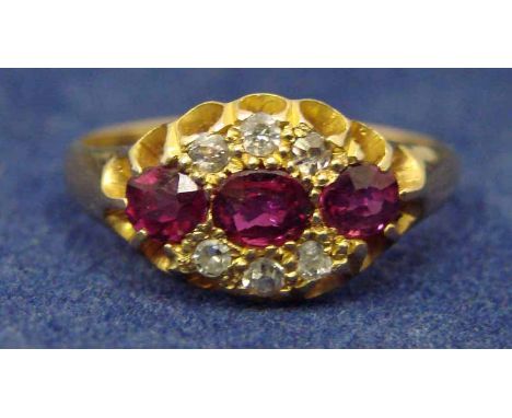 An 18ct gold ruby and diamond Gypsy style ring, set linearly with three rubies, the central stone flanked either side by thre