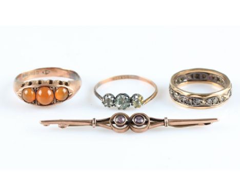 A lot to include, a hallmarked 9ct orange stone, three stone ring, together with a three stone paste ring, stamped 9ct, a pas